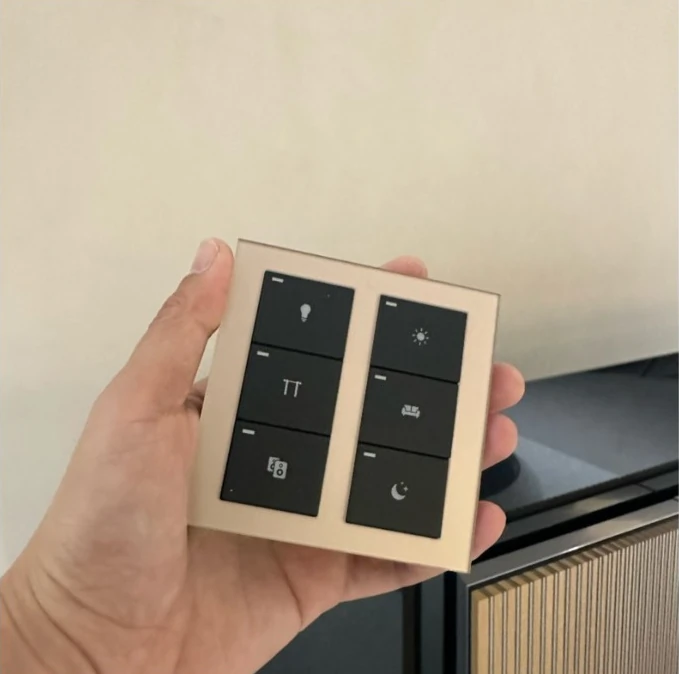 Real HAOJAI E-Series six-key switch held in a hand, showing its glass face and button layout