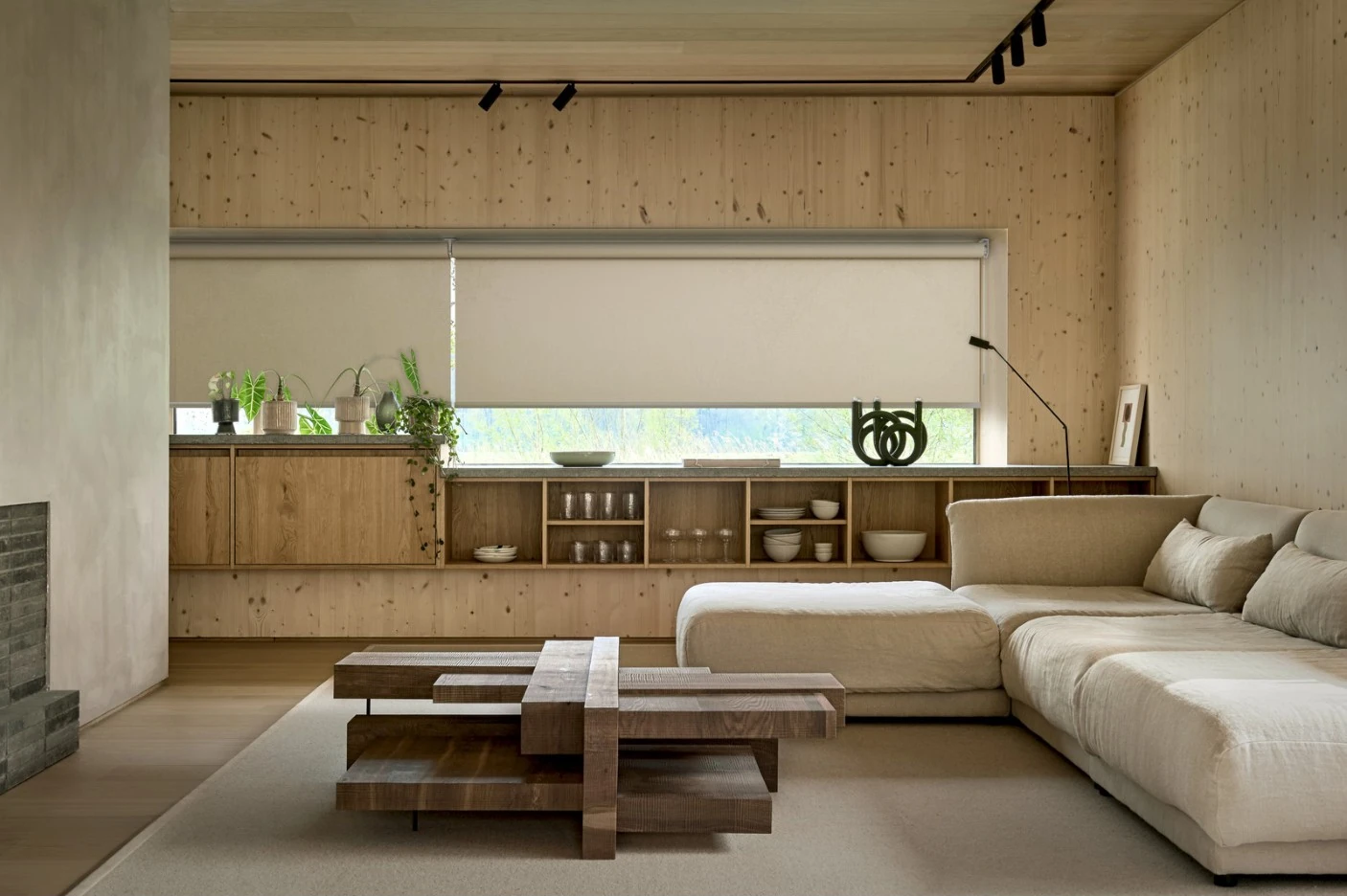 Warm timber living room with soft daylight, neutral seating and window shading
